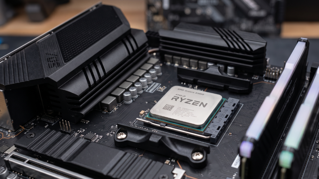 A modern AMD processor installed into a black B450 series motherboard.