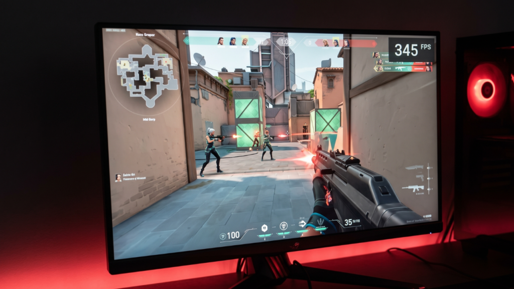 A photorealistic close-up of a computer monitor displaying the game Valorant with a high FPS counter in the corner, illuminated by soft red light from the CPU cooler.